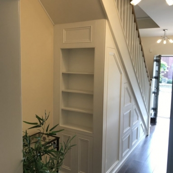 Large six drawer unit with door and slide out coat rack along with a bookcase on the end